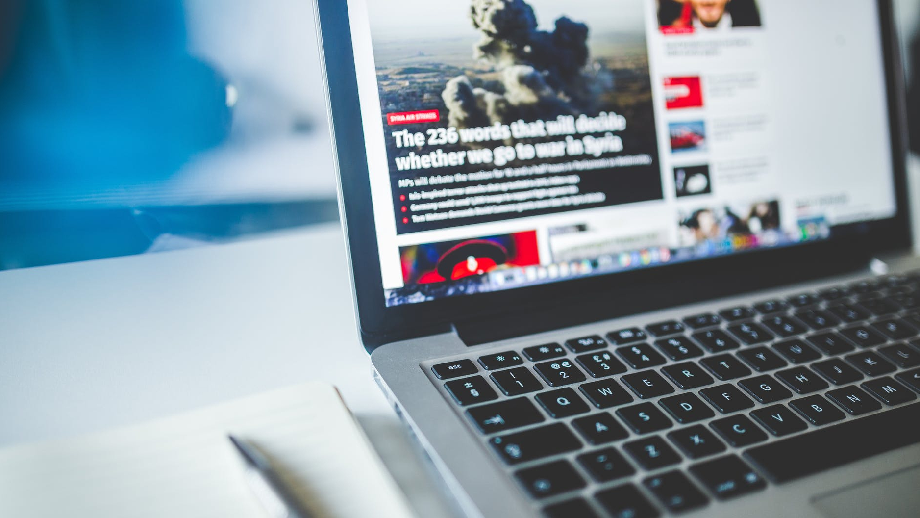 gray laptop computer near journals