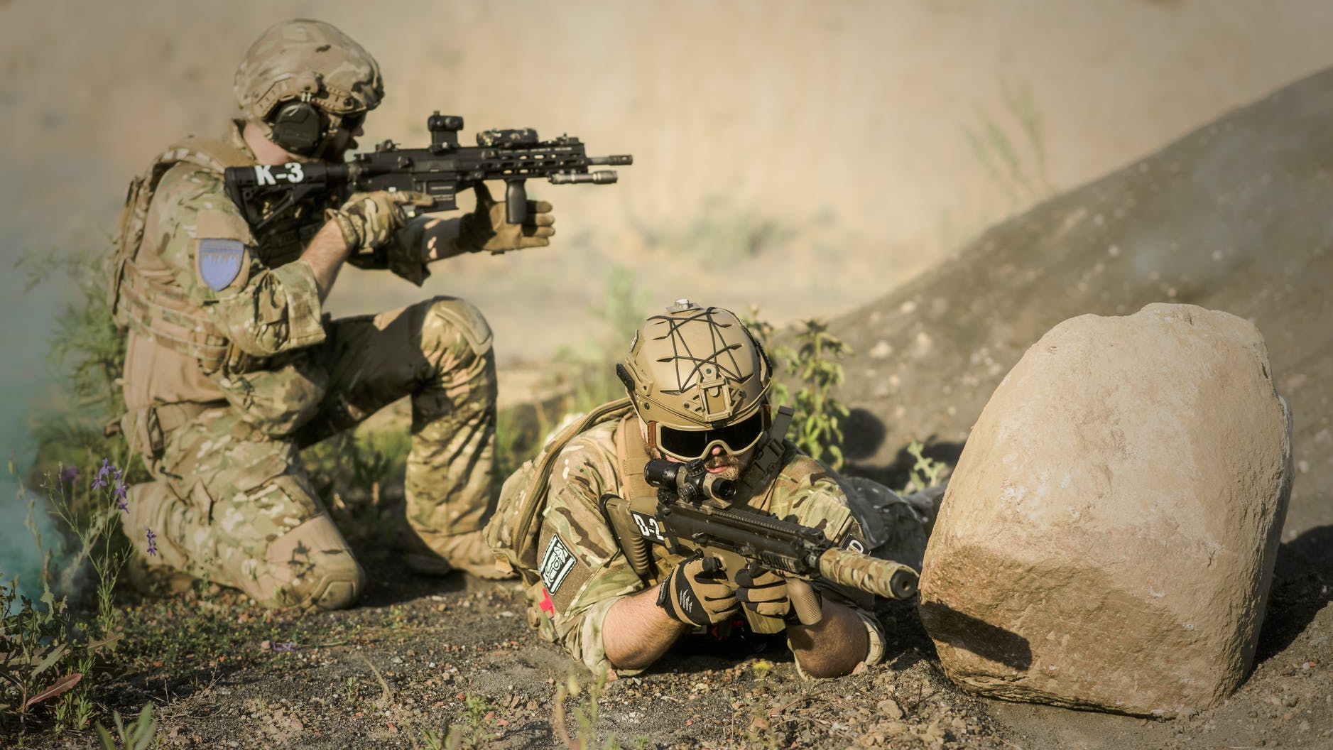 military sniping near rock