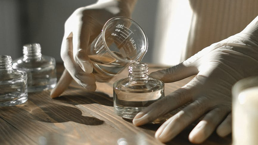 crop black woman making aromatic liquid incense