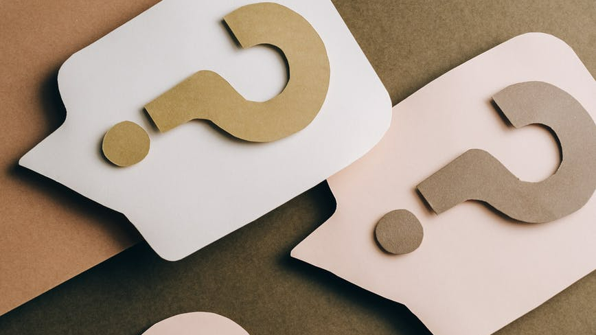 question marks on brown surface