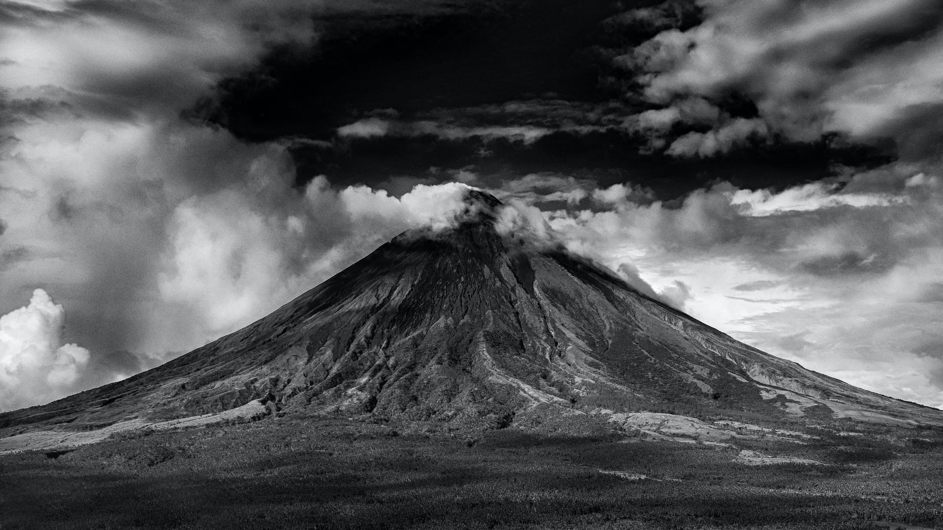 gray scale photo of active volcano