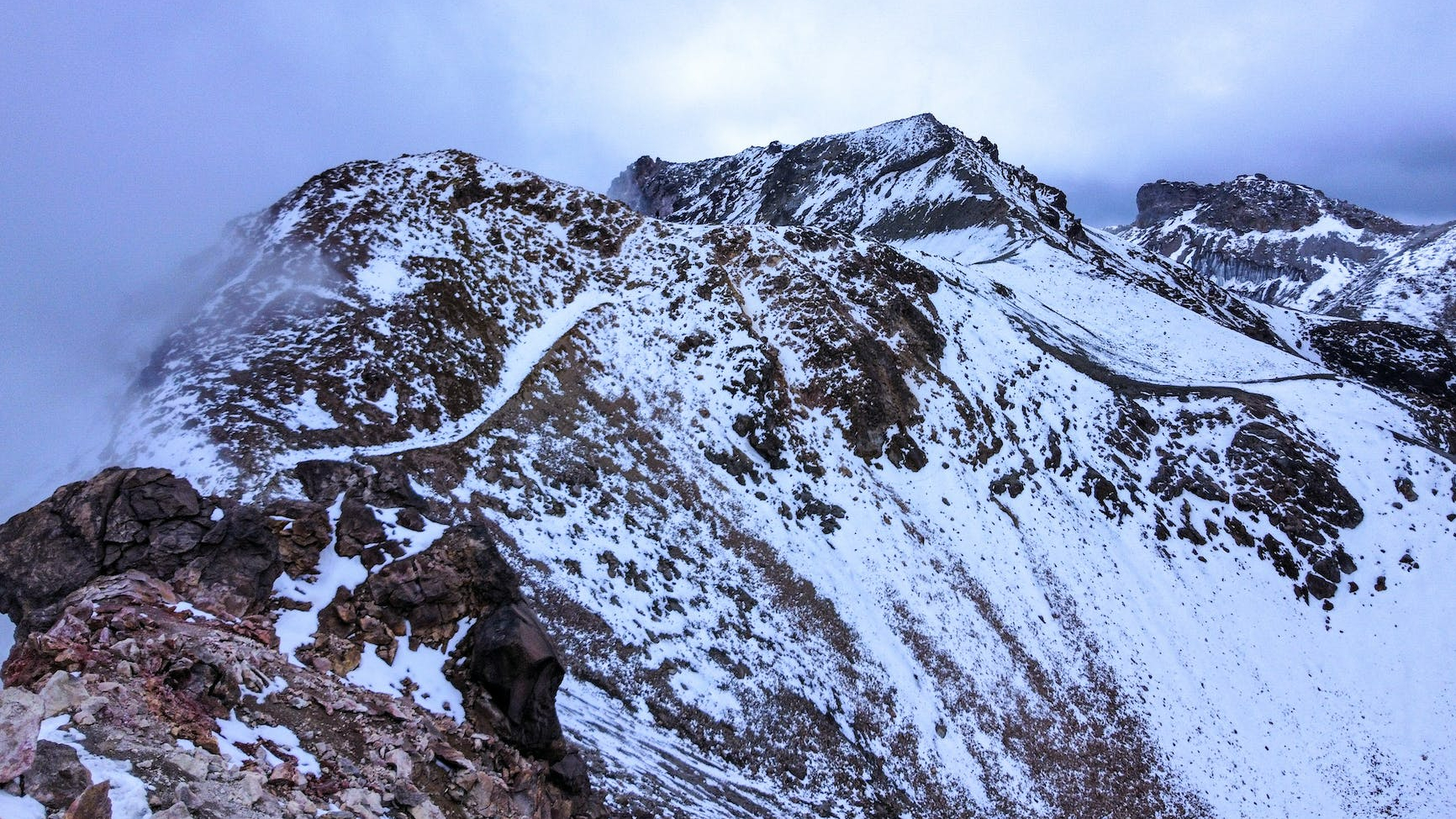 snow covered mountain under blue sky