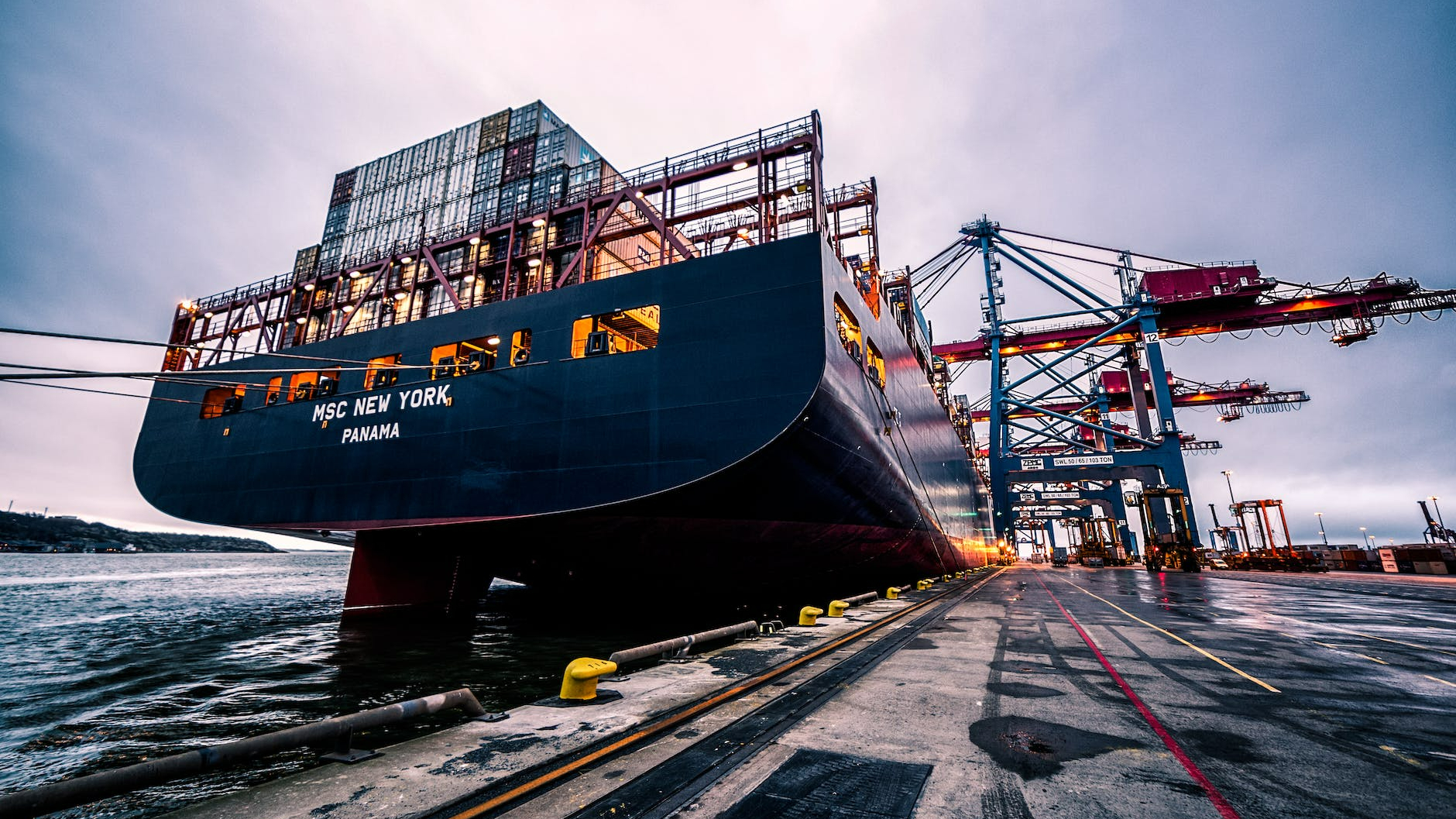 black sail ship on body of water