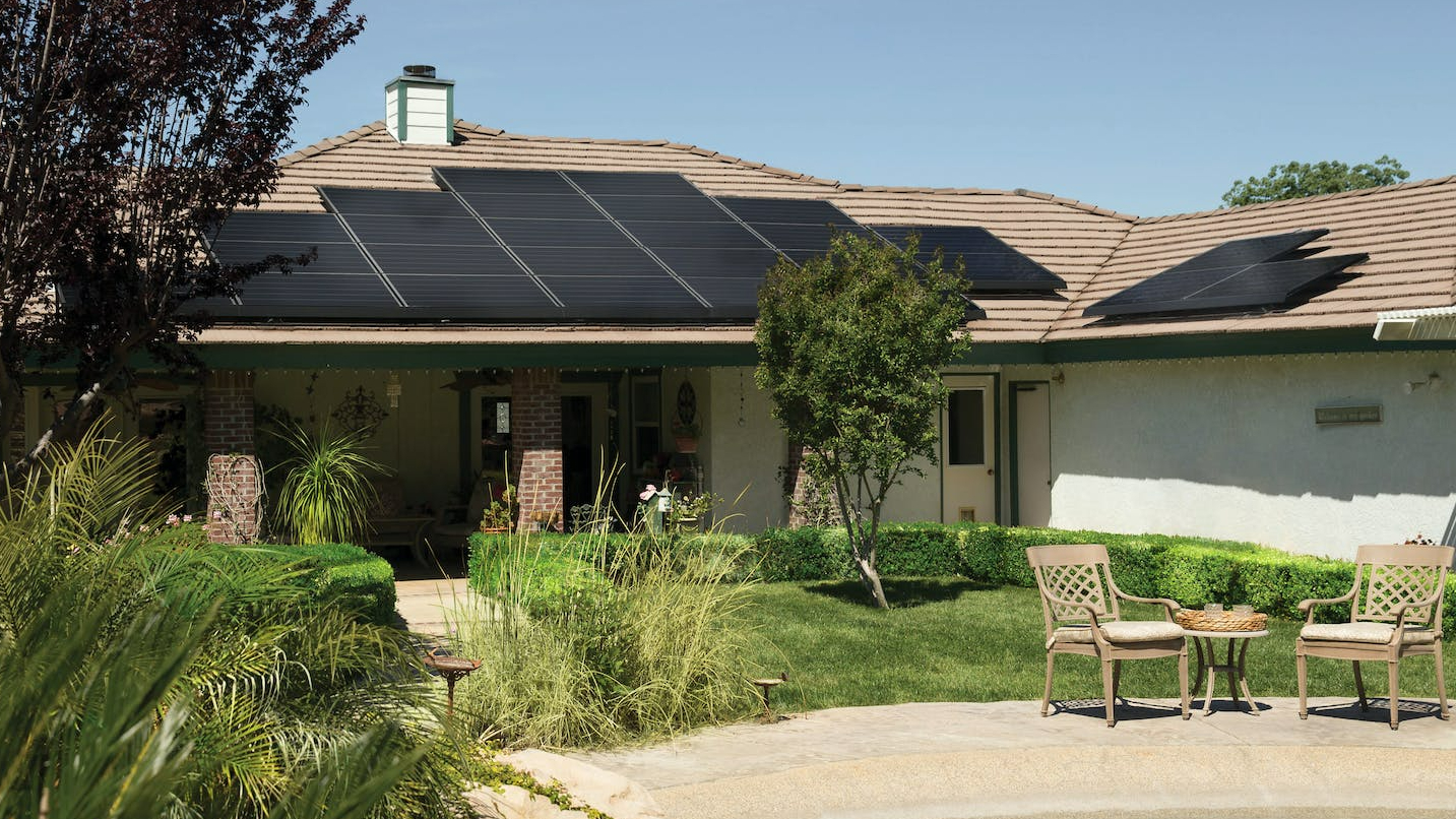 black solar panels on brown roof
