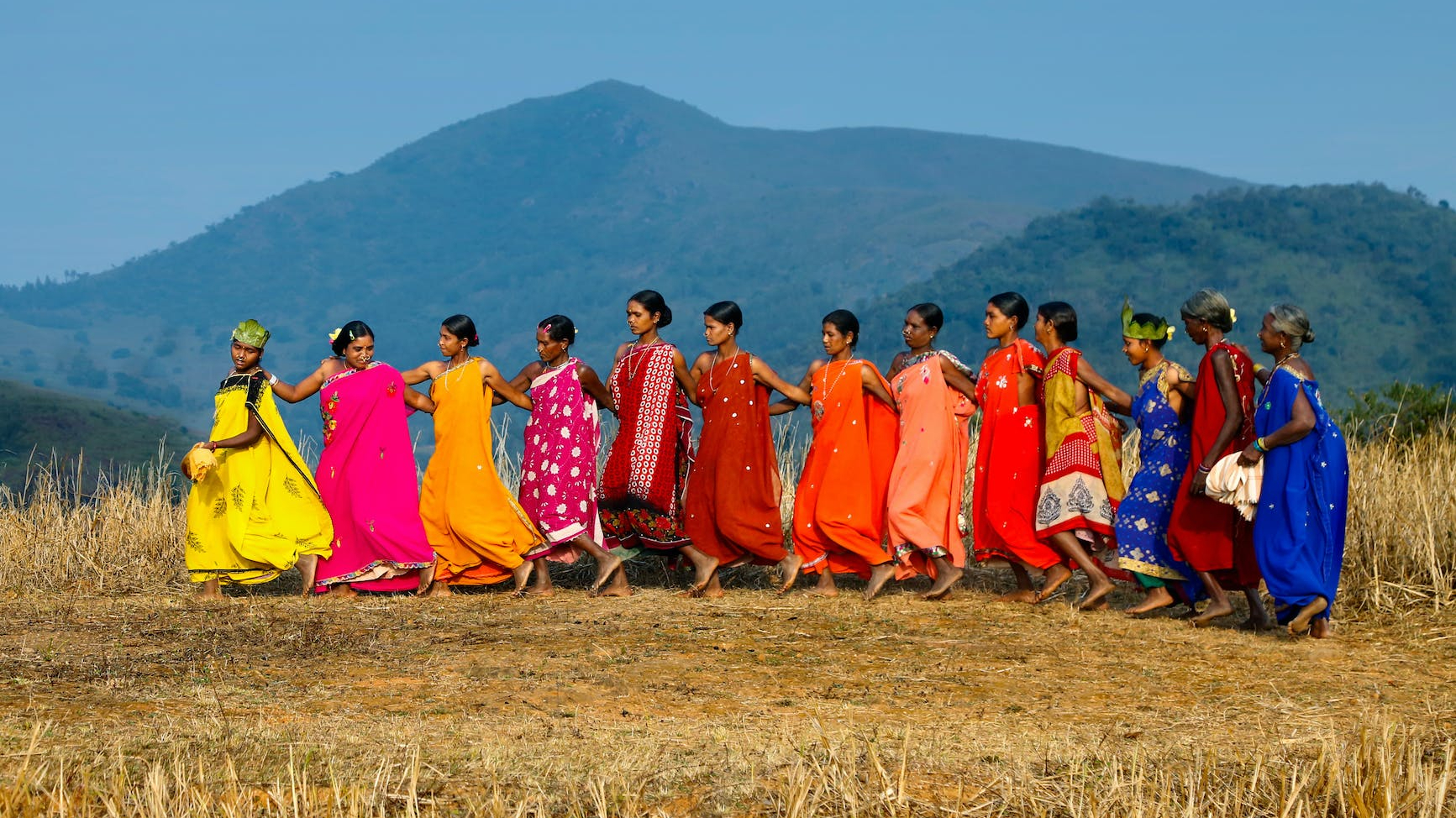 group of people in standing on brown grass field