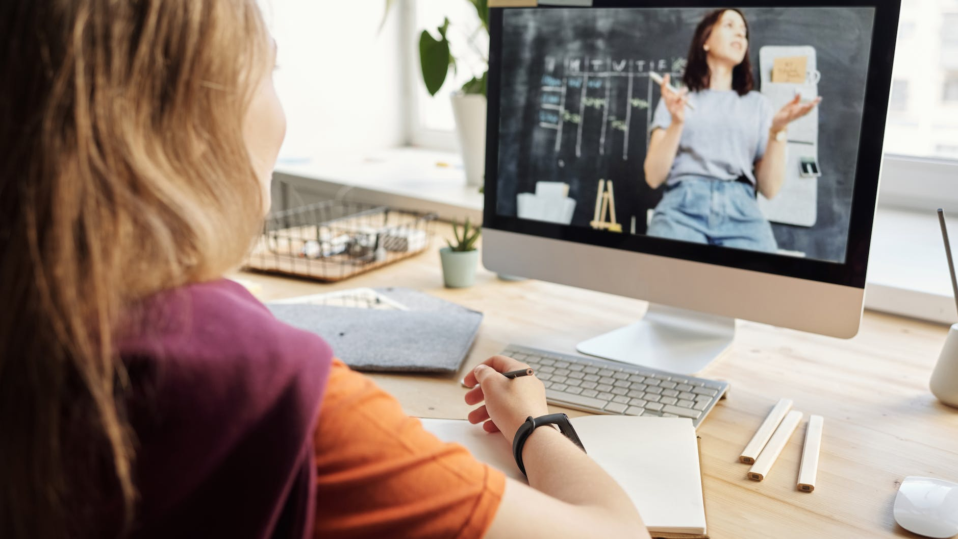 photo of girl watching through imac